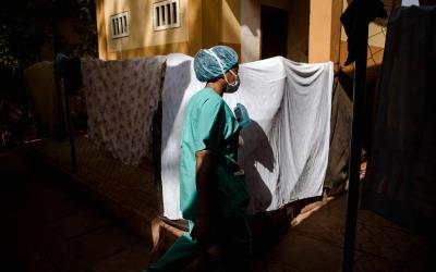 The MSF nurse supervisor walks through the Centre de Traitement Epidemiologique in Siguiri, Guinea.